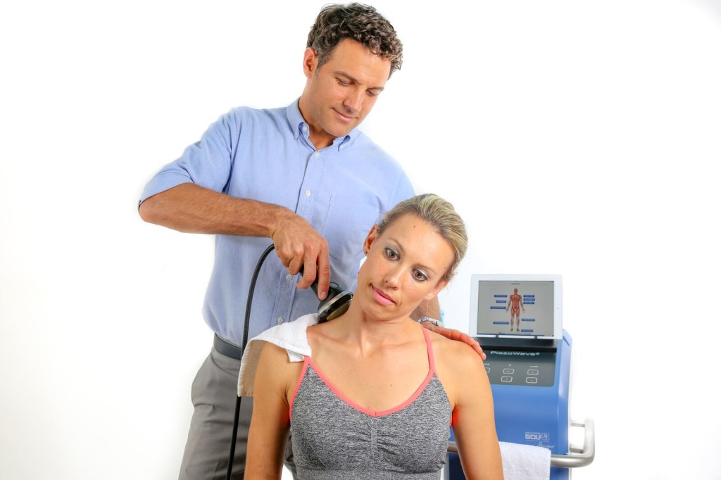 Extracorporeal Shockwave Therapy ESWT.Effective non-surgical  treatment.Physical therapy for lower back with shock waves.Pain relief,  normalization and regeneration,stimulation of healing process. Stock Photo